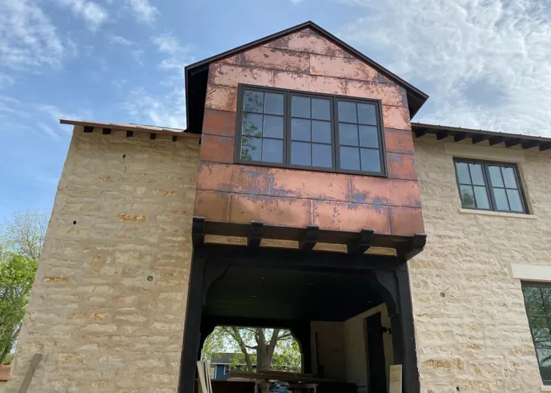 Copper metal panel facade on a stone building for Roof Repair in Idabel